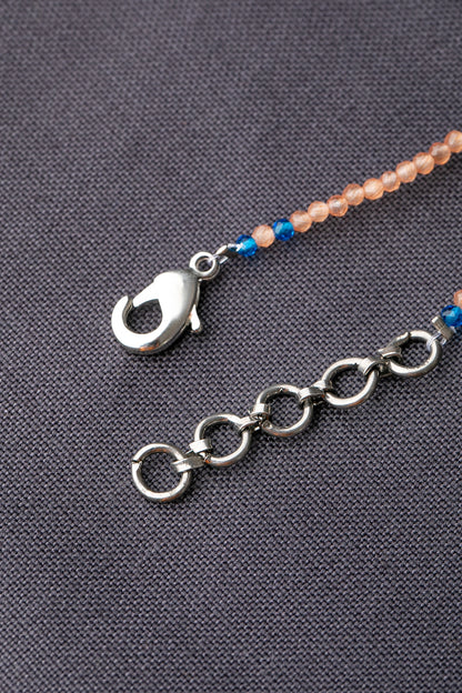 Evil Eye Pendant in Peach Crystal Beads with Blue Accents  White Rhodium Finish  Adjustable  18 Inches