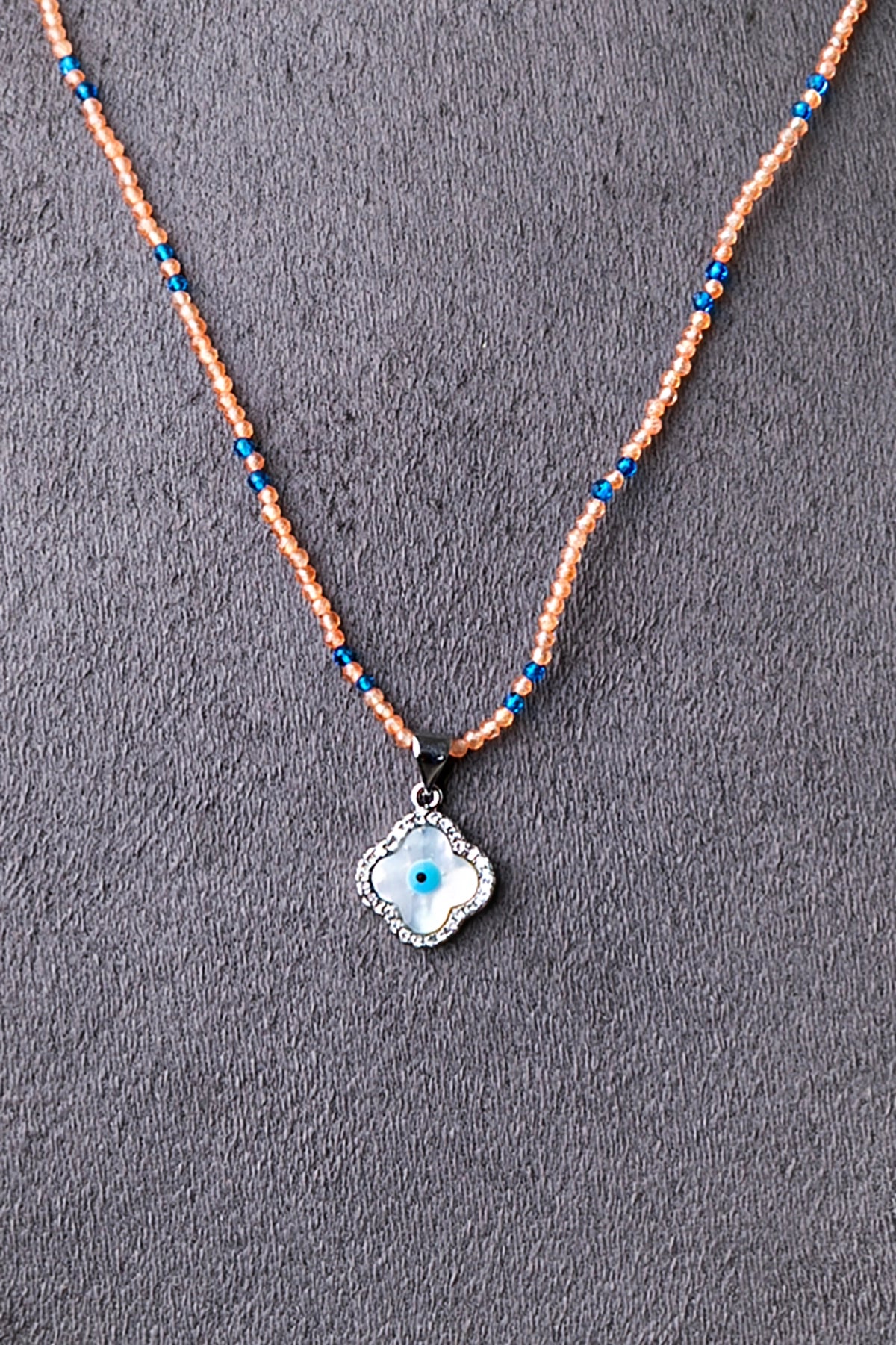 Evil Eye Pendant in Peach Crystal Beads with Blue Accents  White Rhodium Finish  Adjustable  18 Inches