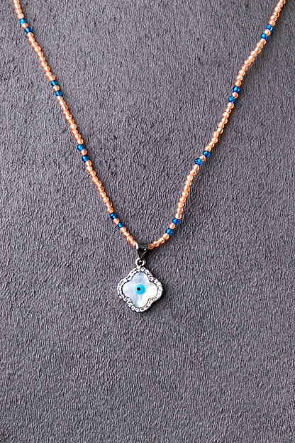 Evil Eye Pendant in Peach Crystal Beads with Blue Accents  White Rhodium Finish  Adjustable  18 Inches